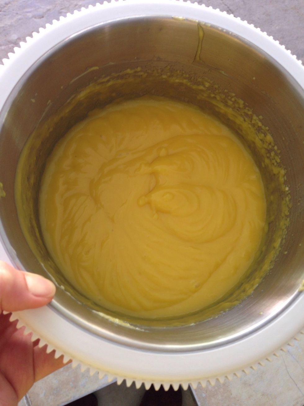 Gradually add the cooled cream and mix very well.