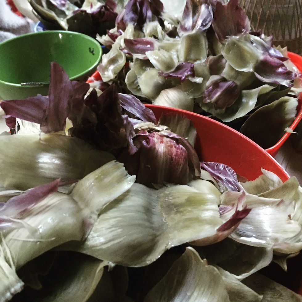 Gradually, as you thin out the artichoke's leaf. Put the leaves in a container (after, you can put them on a compost if you have one, or discard).