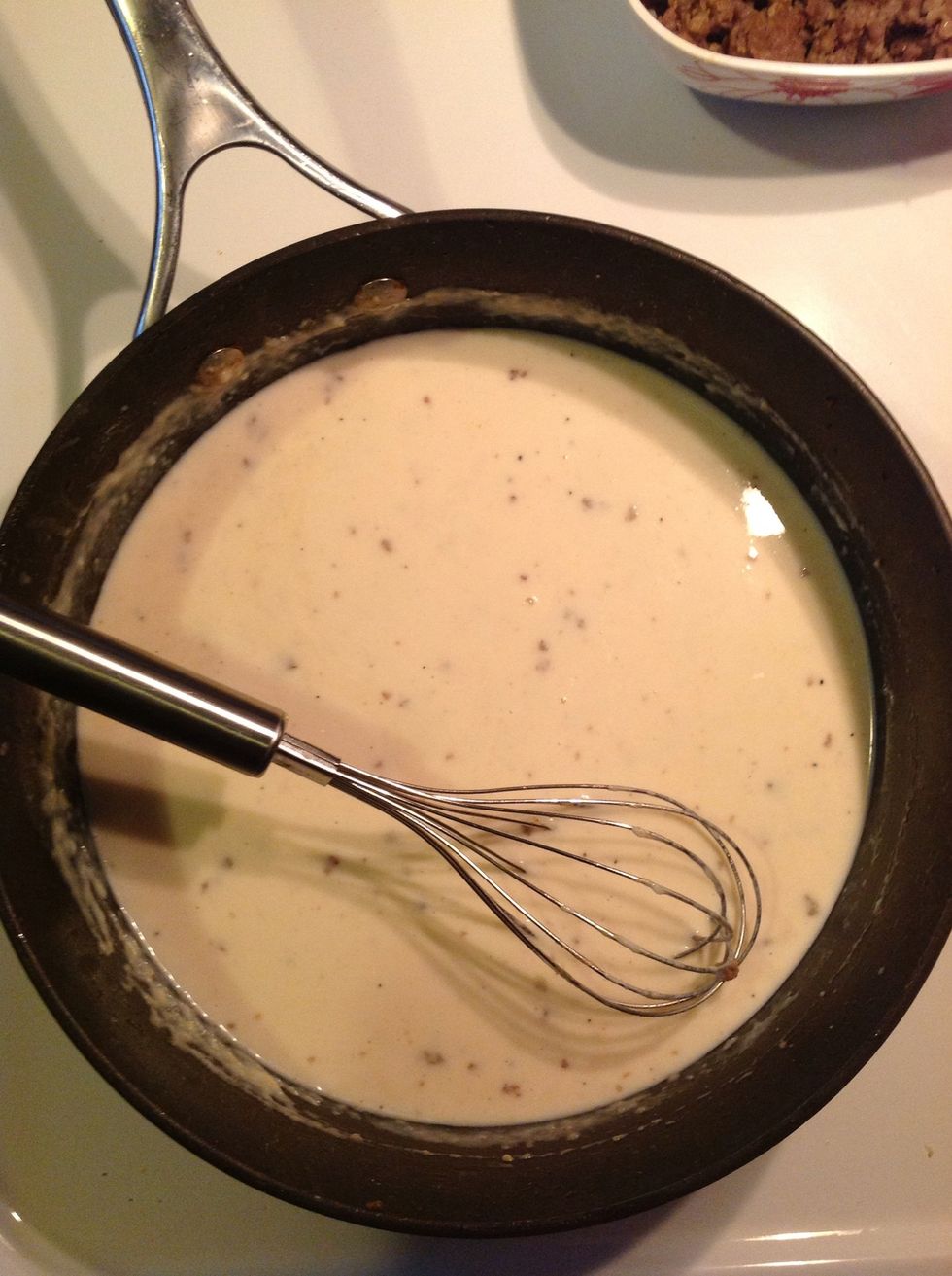 Gradually start adding your milk and whisk. Bring to a boil.