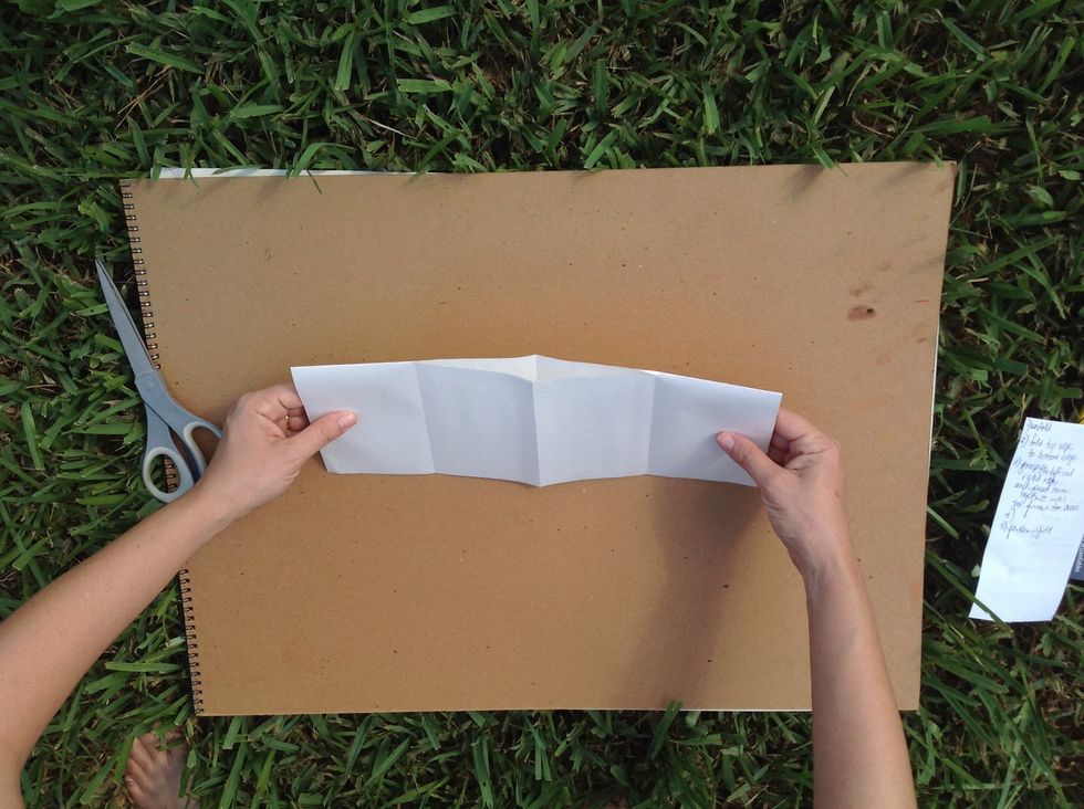 Grasp the edges and move your hands towards each other.