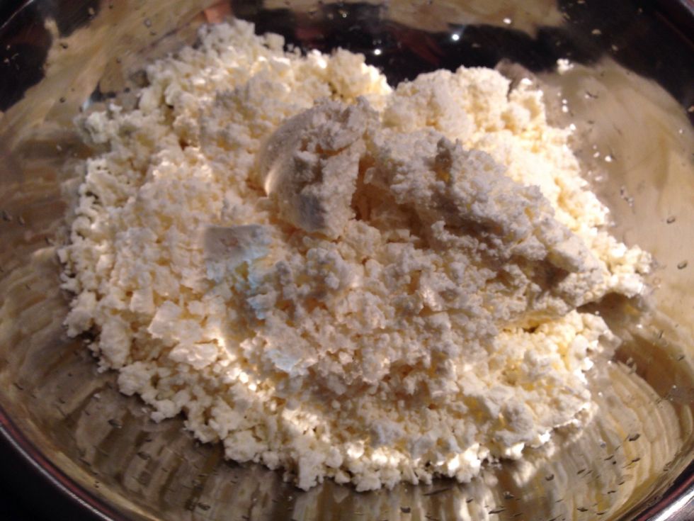 Grate all the feta and add all the ricotta into a mixing bowl