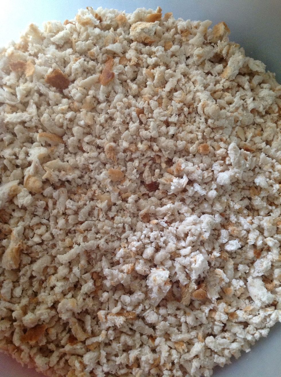 Grate bread. This stuffing is best made from fresh white bread. Store bought breadcrumbs will not do.