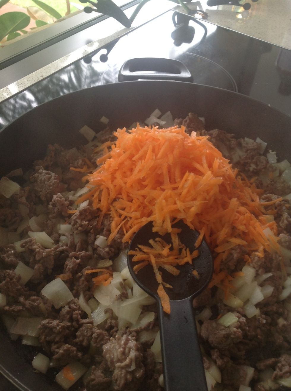 Grate carrot and add into pan