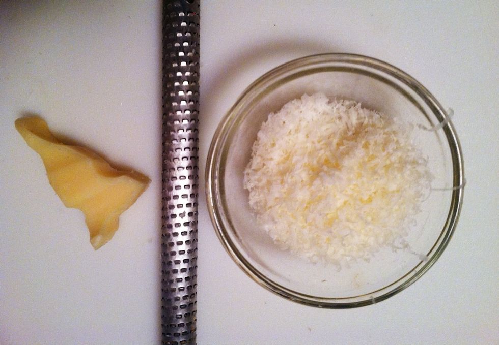 Grate fresh parmesan directly over the top of dish. I used a rasp (above) for a very fine shaving. Or if it's already grated, sprinkle it on the top.  Parmesan is salty so just a thin layer is enough.