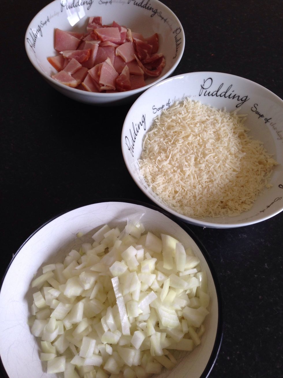 Grate half of the cheese (we won't use the other half), chop the onion into small bits and cut the rashers into small pieces (roughly half inch).