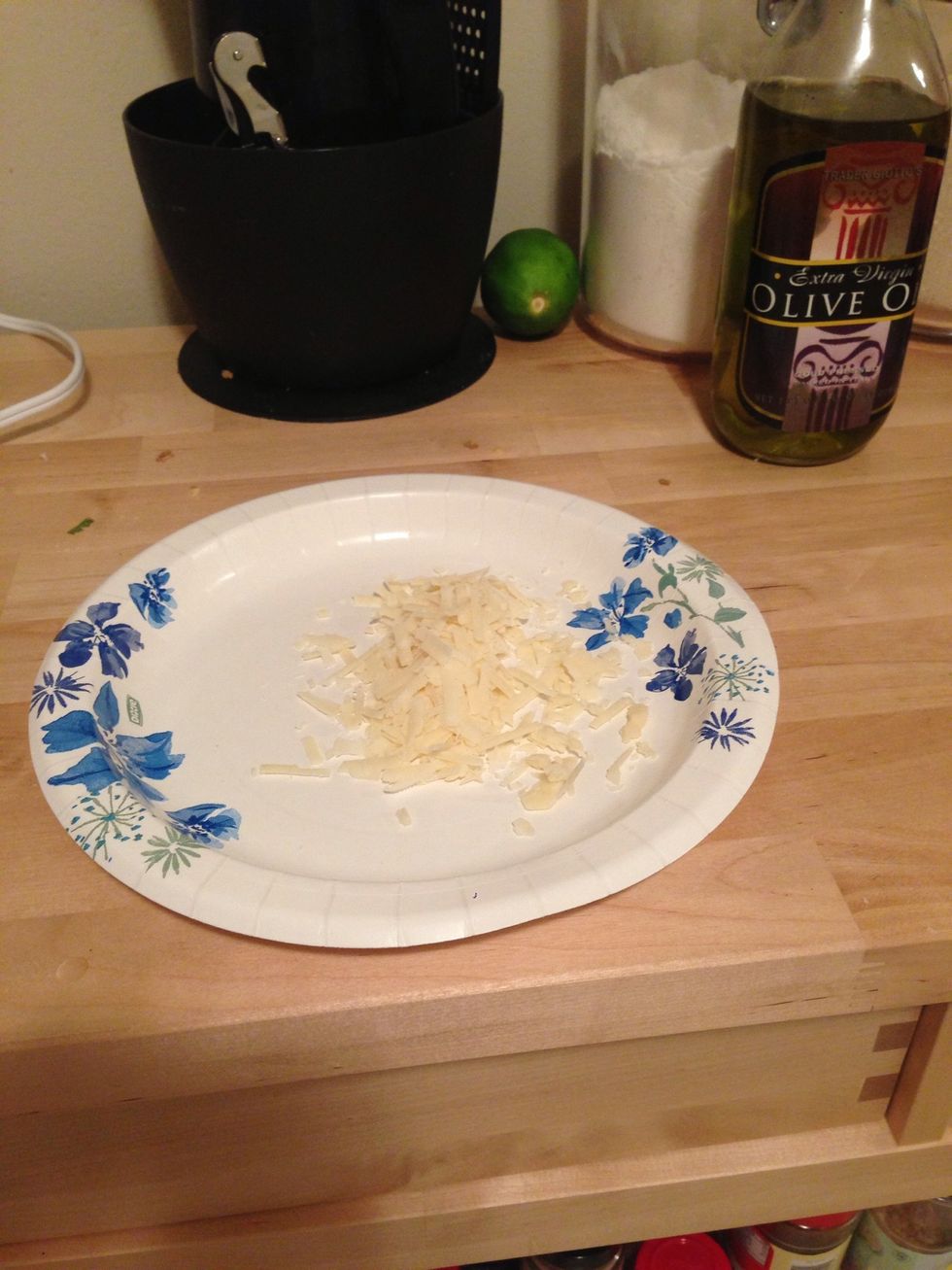 Grate the block of cheese or have shredded cheese. Any white cheese would taste nice with the Parmesan, but I will list a few: asiago, Romano, or provolone.