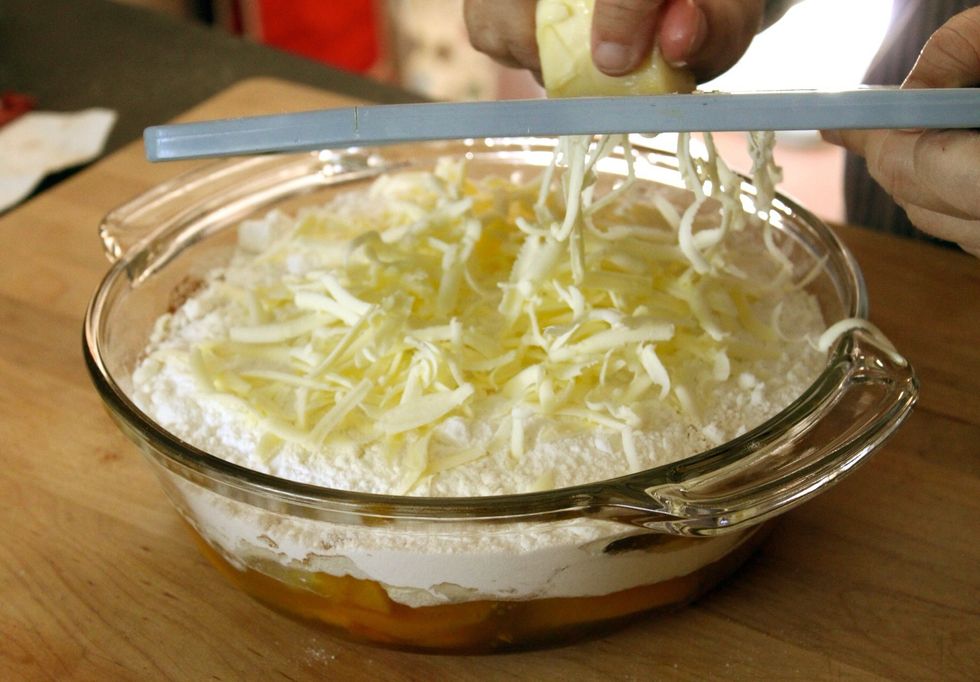 Grate the butter across the top, covering the entire surface.