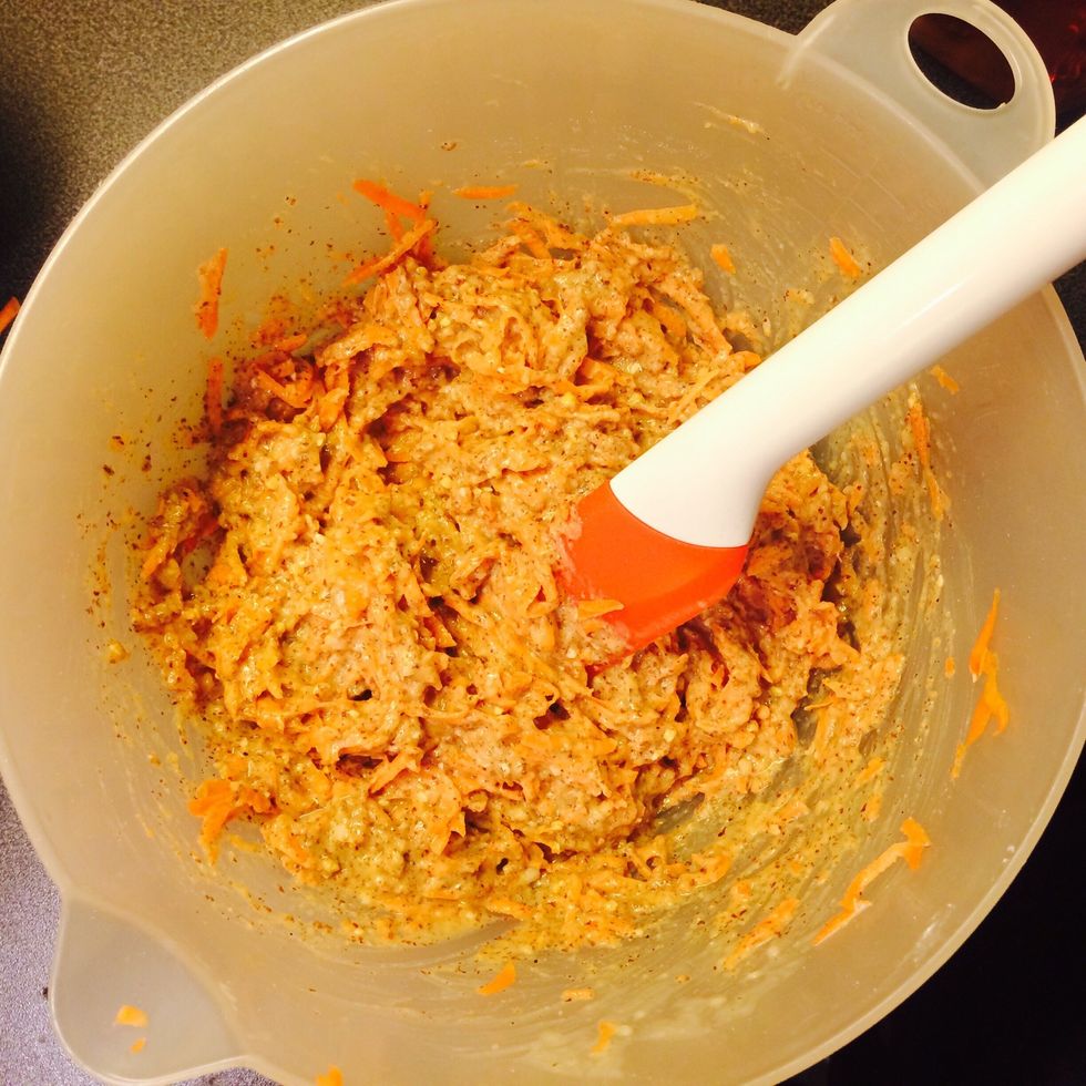 Grate the carrots. Carefully add and fold them into the rest of the mix.