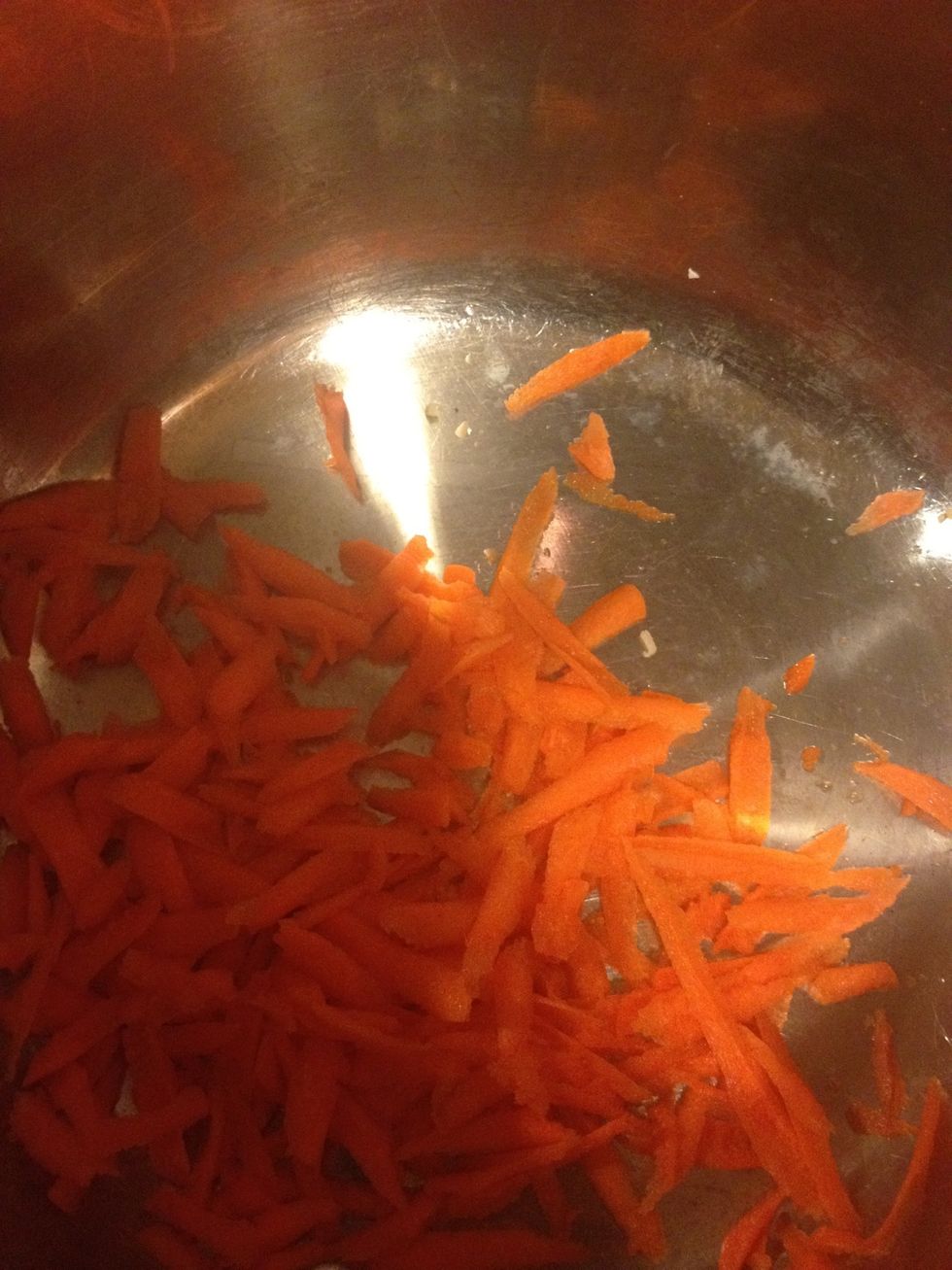 Grate the carrots into thicker strings