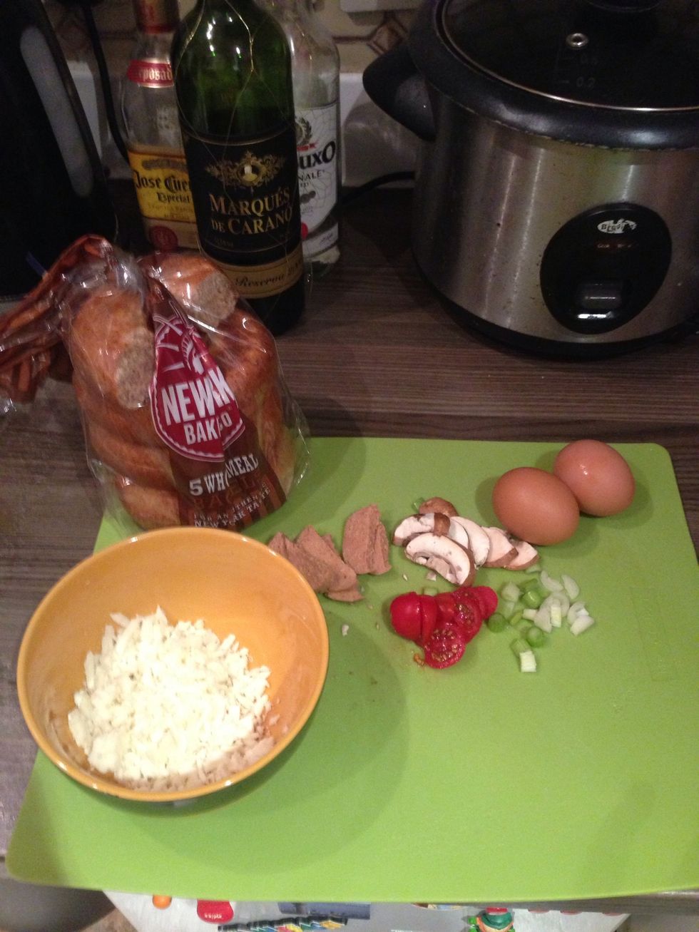 Grate the halloumi, slice the cherry tomatoes, mushroom, onion and sausage.\ud83d\udc40 (Sorry about the wine and rice Cooker lol\ud83d\ude49)