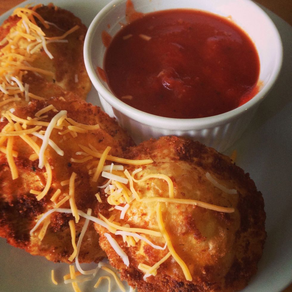 Grated cheese on top of the ravioli and served it with marinara sauce for dipping.