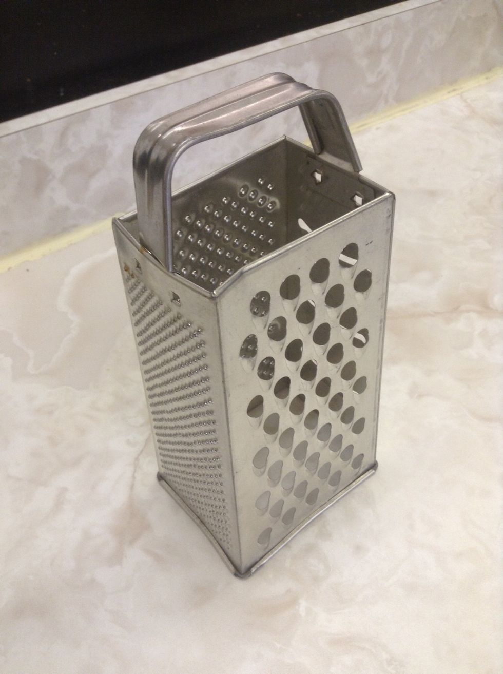 Grater. Used to shred. I can use a grater to shred chocolate for a dessert topping.