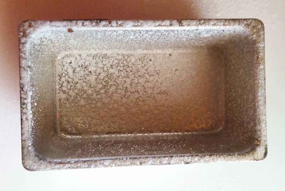 Grease a loaf pan. Using the 2 tablespoons of reserved flour, sprinkle on board. Knead the dough and make into a loaf shape. Place in loaf pan, cover, and leave in a warm place for 45 more minutes.