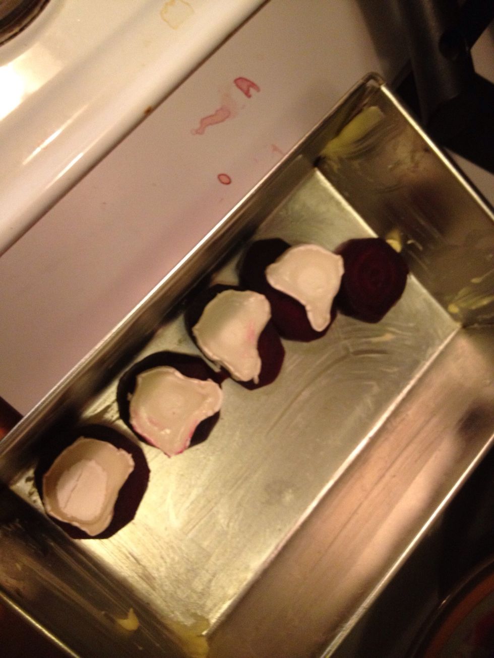 Grease a pan and add the beetroot slices and then the ch\u00e8vre/goat cheese on top.