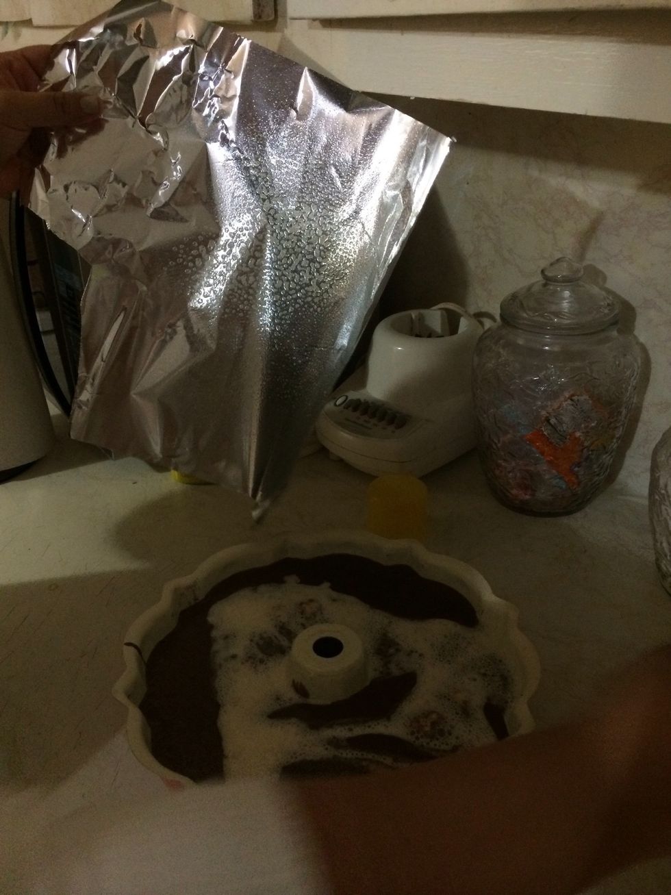 Grease a piece of foil paper & cover the pan