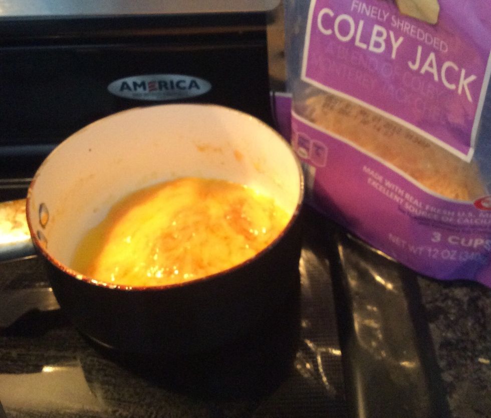 Grease a sauce pan and add one cup of cheese. Let melt and add any pieces of meat and vegetables you may want