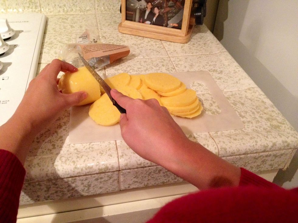 Grease an 8x8 casserole dish with cooking spray and set aside. Cut polenta into 1/8" slices.