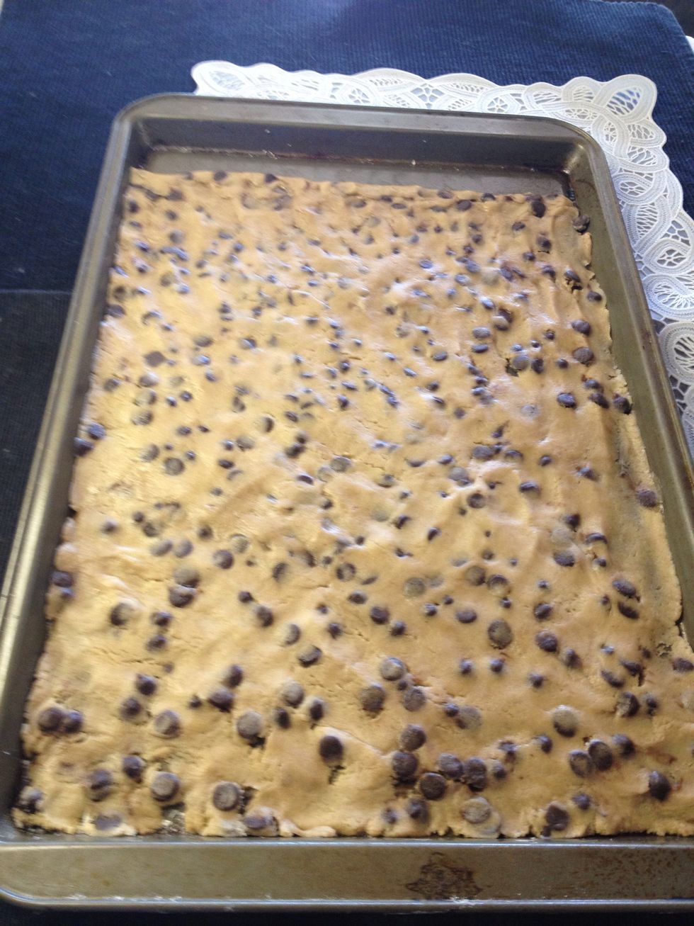 Grease and press into  a 12" round pizza pan. I didn't have one so I used a cookie sheet. Use flour on your fingers to prevent them from sticking to the dough.