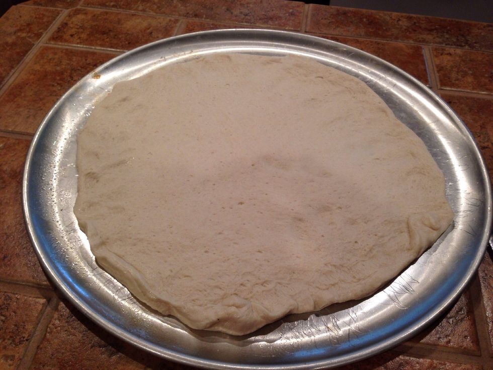 Grease the pan and spread out the dough.