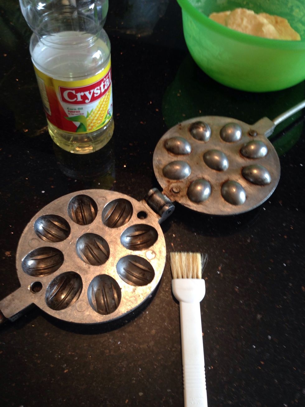 Grease the pan, heat it on stove .