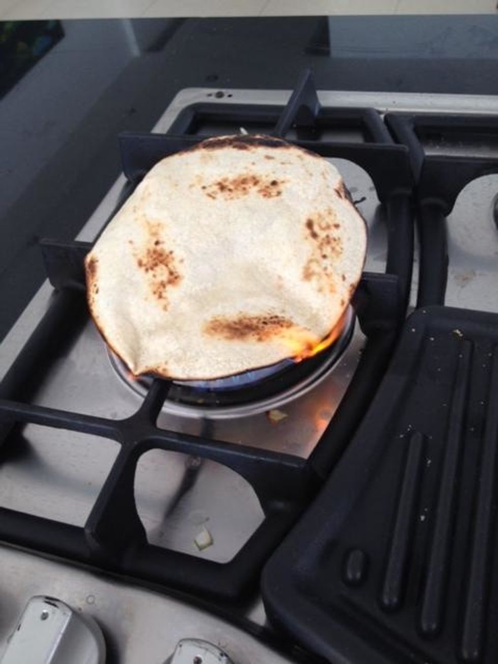 Grill a tortilla on your burner (it'll work on electric too) till it's toasty and scorched. Plate your hummus by spreading it out over a plate, drizzle olive oil, sprinkle paprika. Serve with lemons.