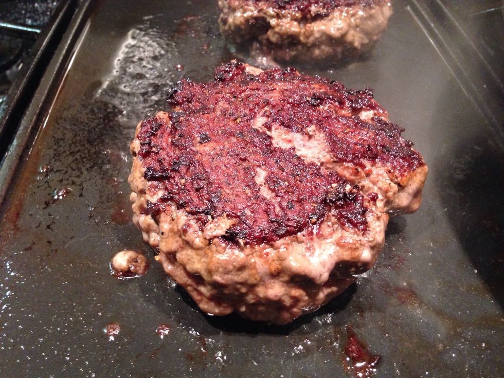 Grill, cast iron or flat top is your choice. Don't move the patties around too much, poke to check doneness but don't slice into the burger.