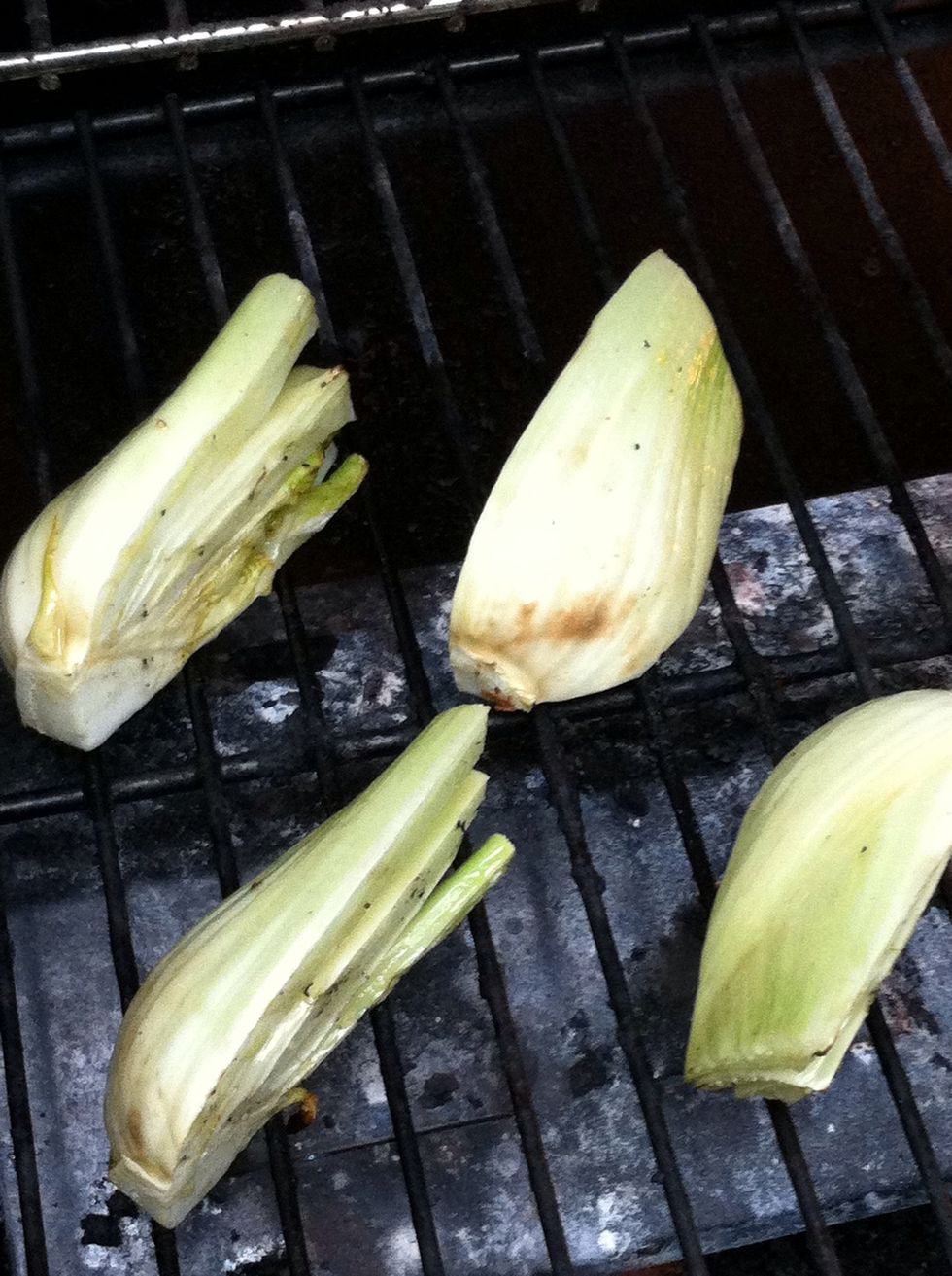 Grill fennel over medium-high heat until it just begins to soften (about 9 minutes) turning occasionally. Reserve the lemon juice and oil In the bowl.