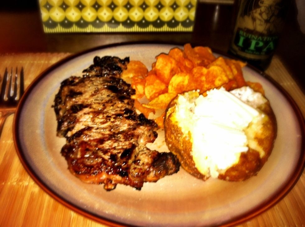 Grill steak for 18 minutes over a medium to low fire or until desired state. Then eat your potato, steak and some chips or whatever.