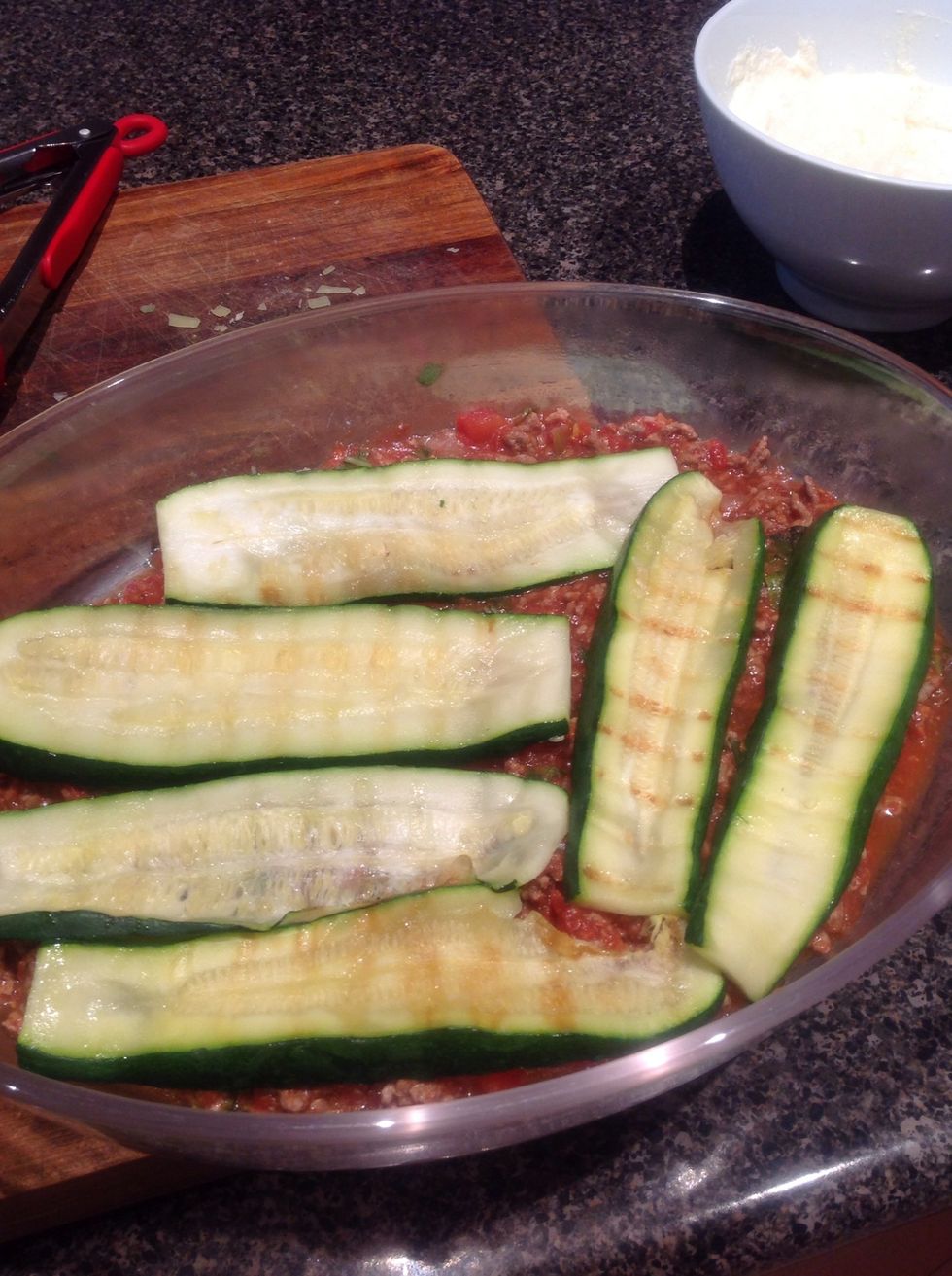 Grill zucchini. Layer dish with meat sauce, then zucchini, then...