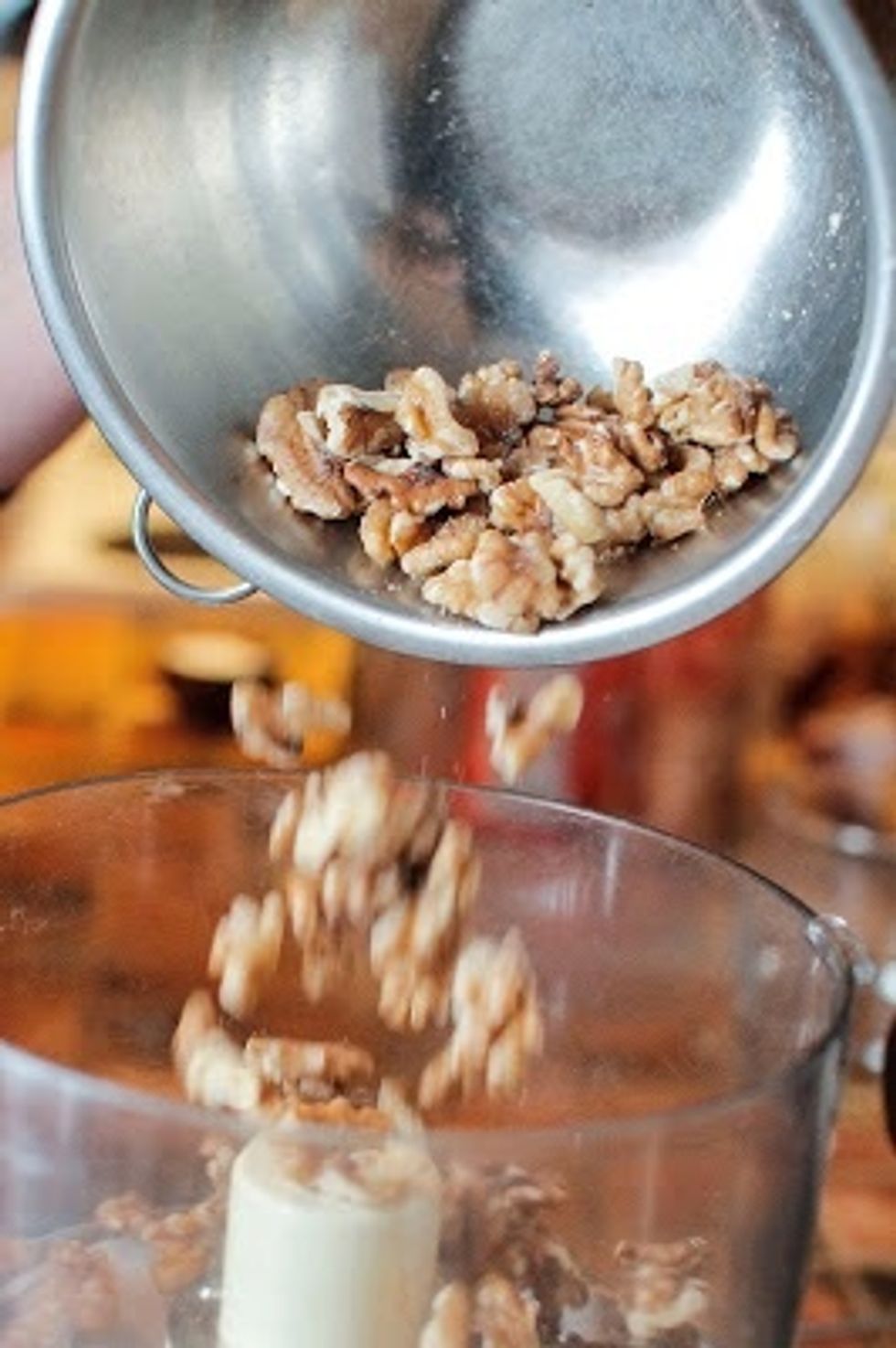 Grind 3/4 cup of walnuts to a fine meal.