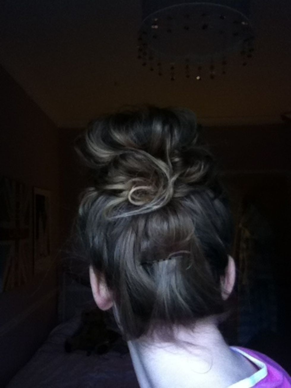 Grip any random bits of hair to the back of your bun