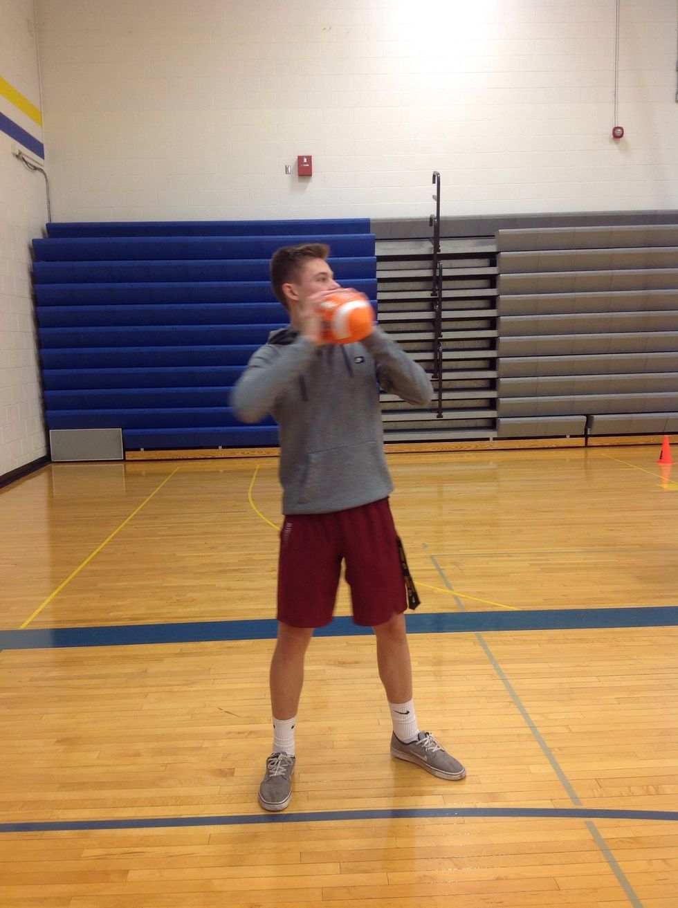 Grip the ball with both hands and look for a target