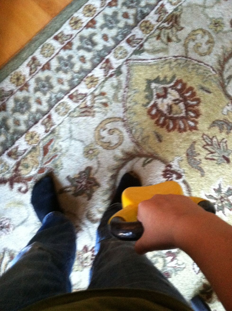 Grip the bell as shown. Hold it with your fist parallel to your legs.