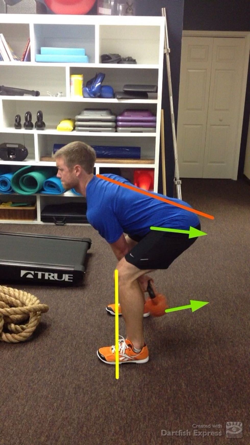 Gripping the KB initiate a slight backswing while maintaining a rigid torso.