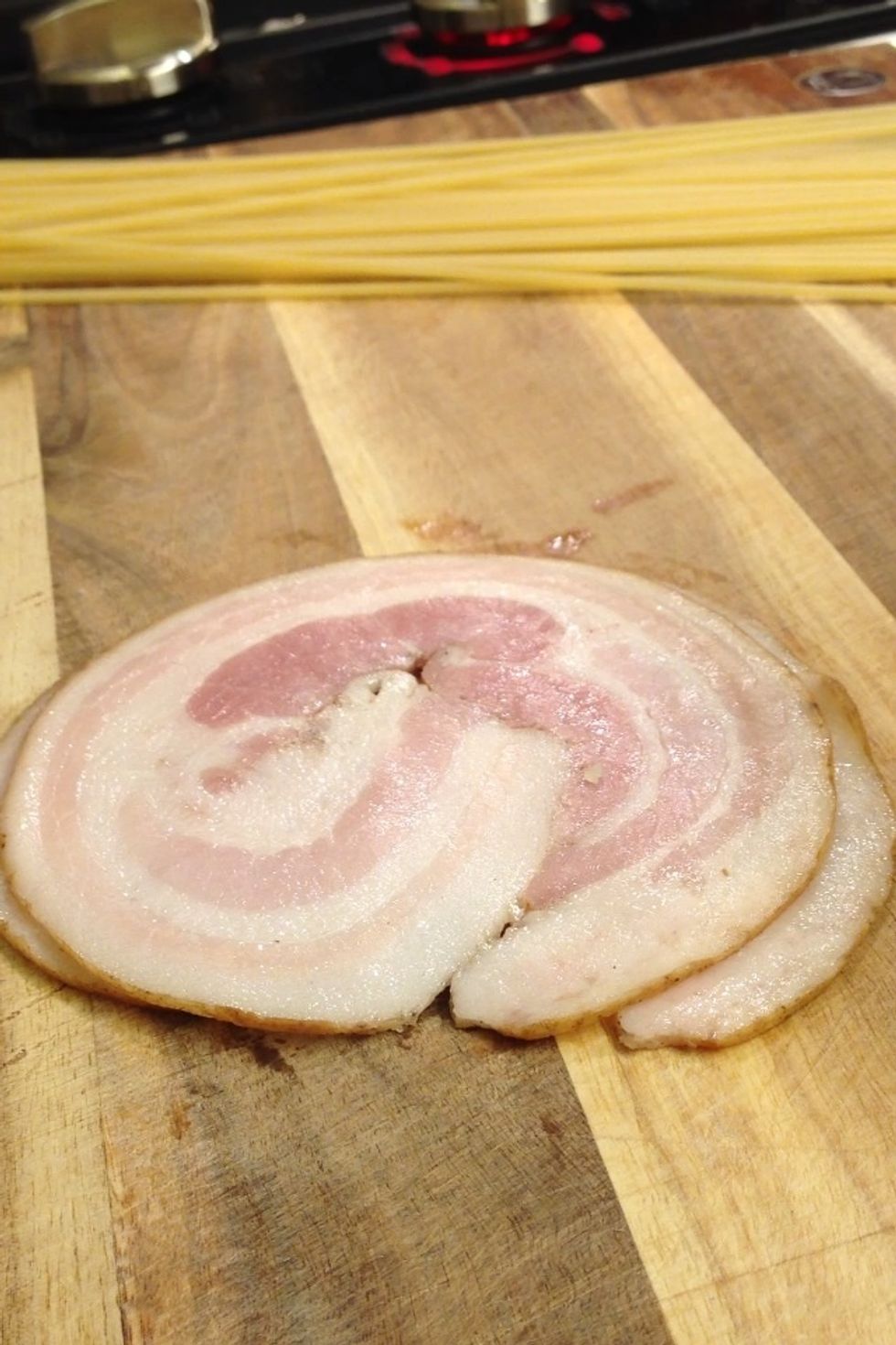 Guanciale, which is unsmoked Italian bacon prepared with pig's jowl or cheeks. Fail to find that, use pancetta.. Or bacon would work too.