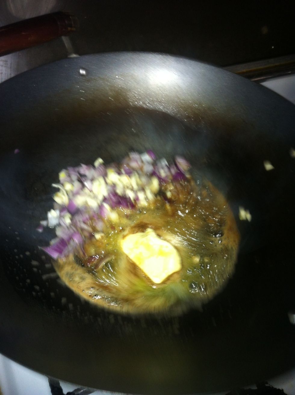 Half butter and put the onion and then the garlic..