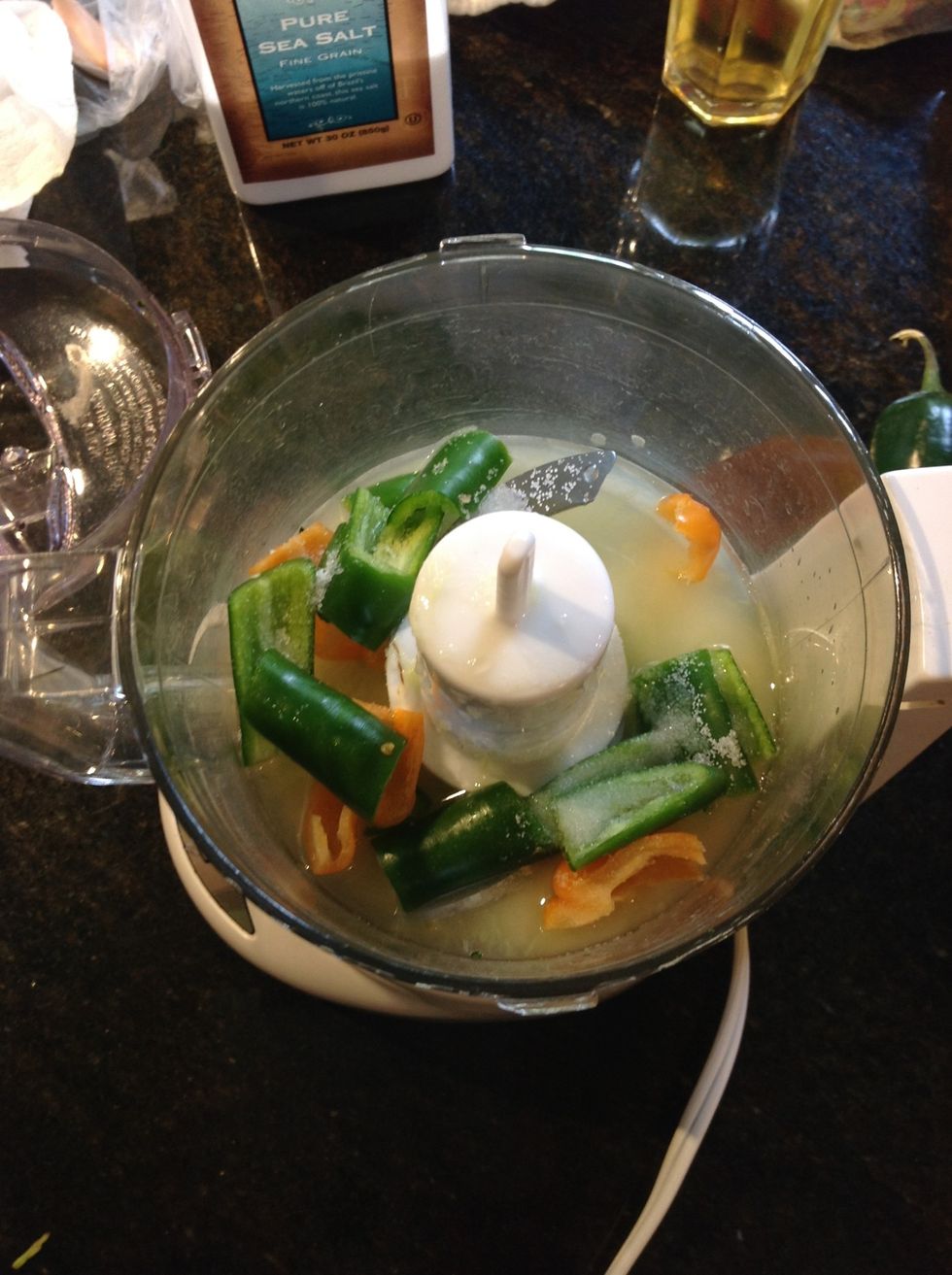 Halve, core de-seed and coarsely chop 2 Serrano, 1 Habanero chile, 1 clove of garlic, the juice of 1 lime and 1 tsp of sea salt process to fine dice mixture but not a paste.