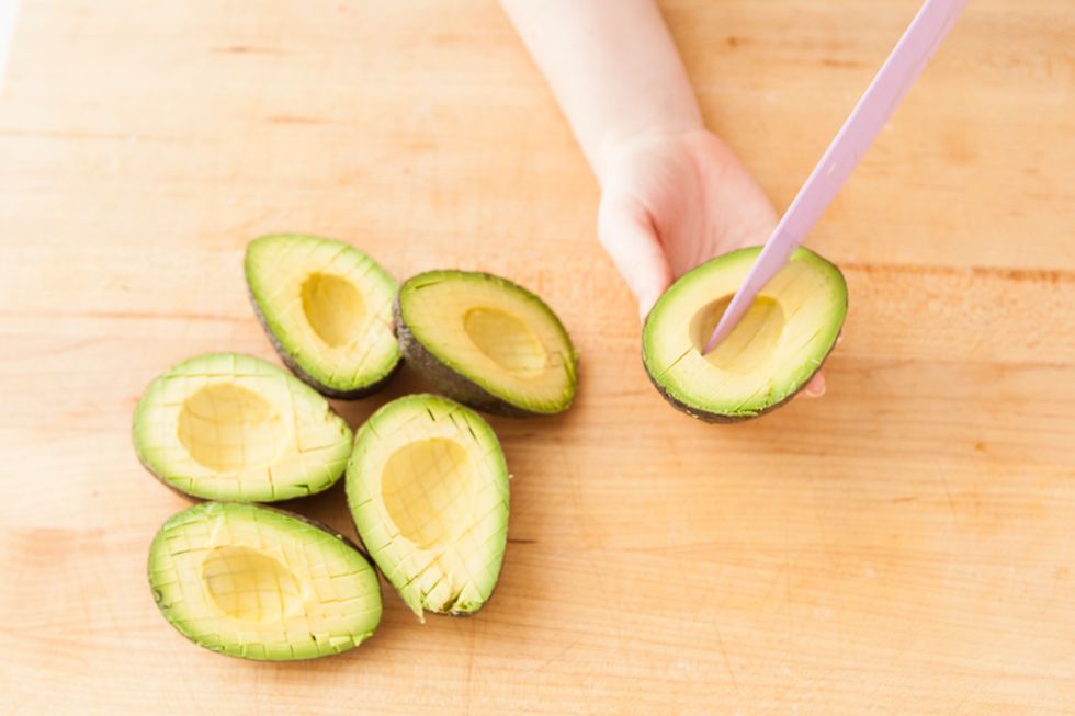 Halve, peel and seed your avocados.