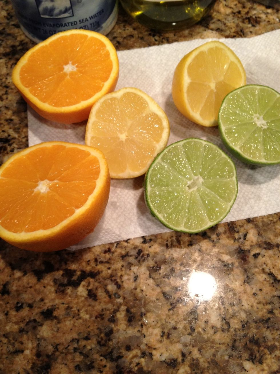 Halve the orange, lemon, & lime.