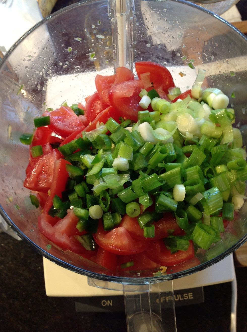 Halve the seeded tomato quarters, core seed and mince 1 or 2 jalape\u00f1os, wash trim and slice 3 to 5 scallions depending on size and taste preference. Add to chile lime mixture in food processor.