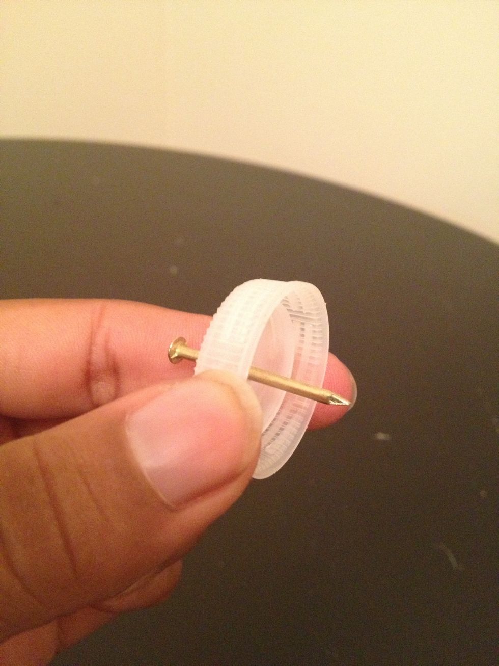 Hammer the nail through and then remove the nail