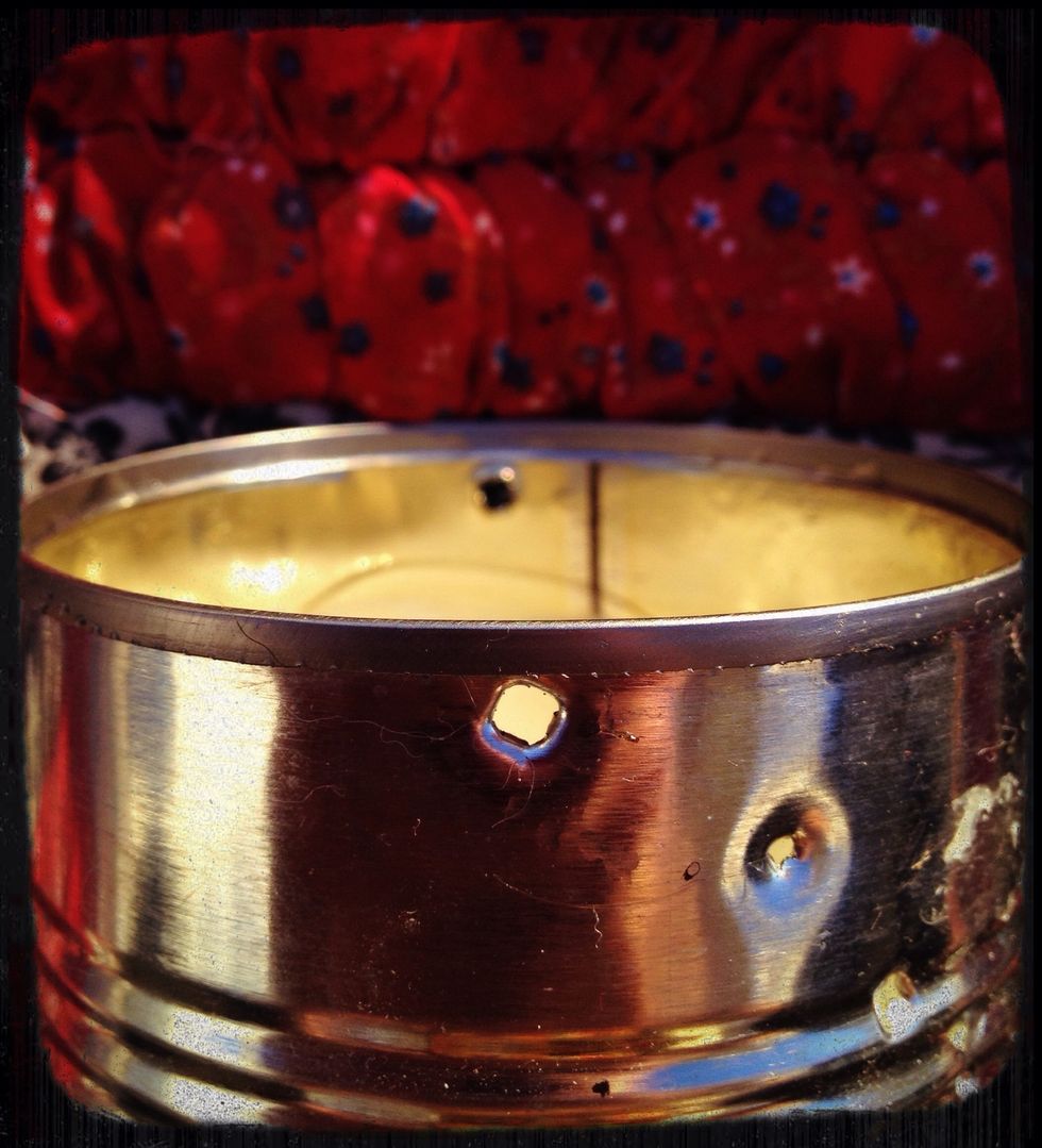 Hammer two holes at the rim, across from each other. The handle will be inserted here.