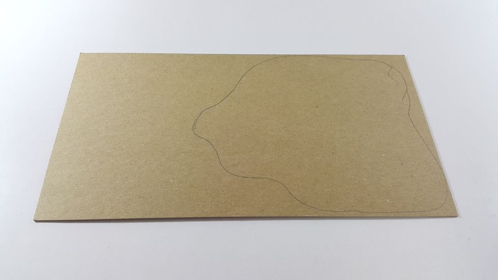 Hand draw a irregular shape on chipboard as platform for the tower, hand cut it out and adhere on paper and trim. After all these steps, you can start decorate your project.