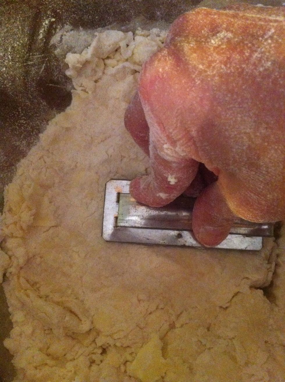 Handle as little as possible, fold the dough over a few times and them pat dough down and cut with a cookie cutter. Continue until all dough is used.