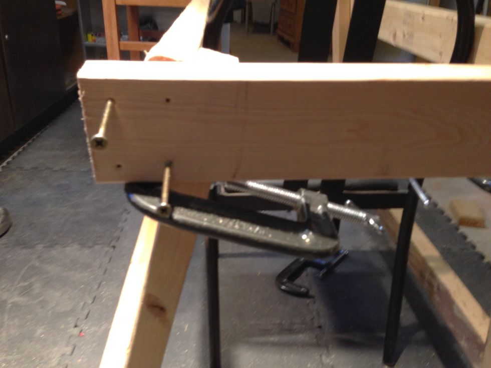 Handy tip: I used a clamp to hold up the wood while screwing in the screws since no one was nearby to help. This worked while taking pictures too!
