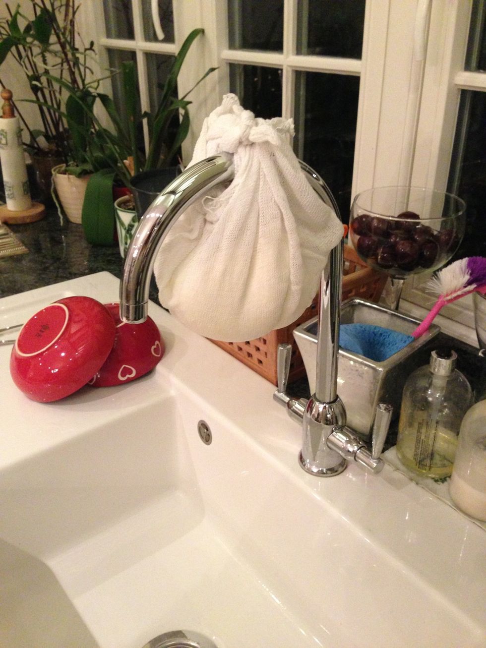 Hang over sink and then leave over night. The whey will start to drip leaving the curd in the sack.