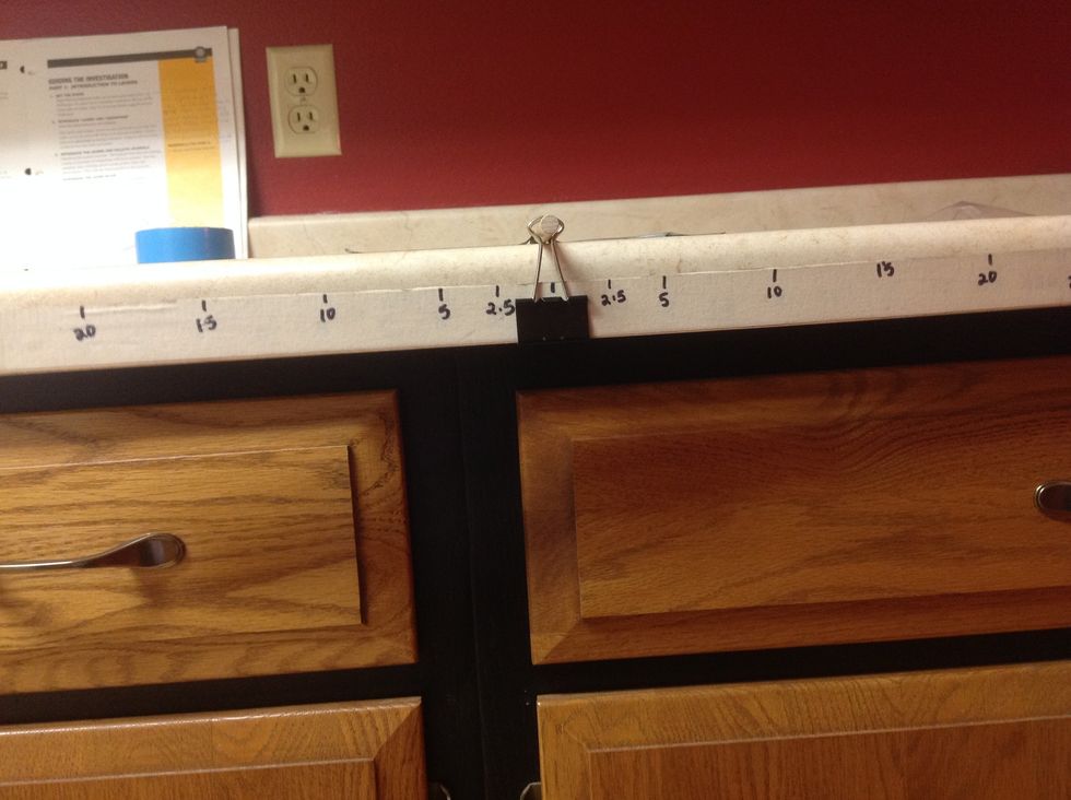 Hang the lever arm on the dowel.  Adjust the location of the clip on the half-meter stick until it balances.