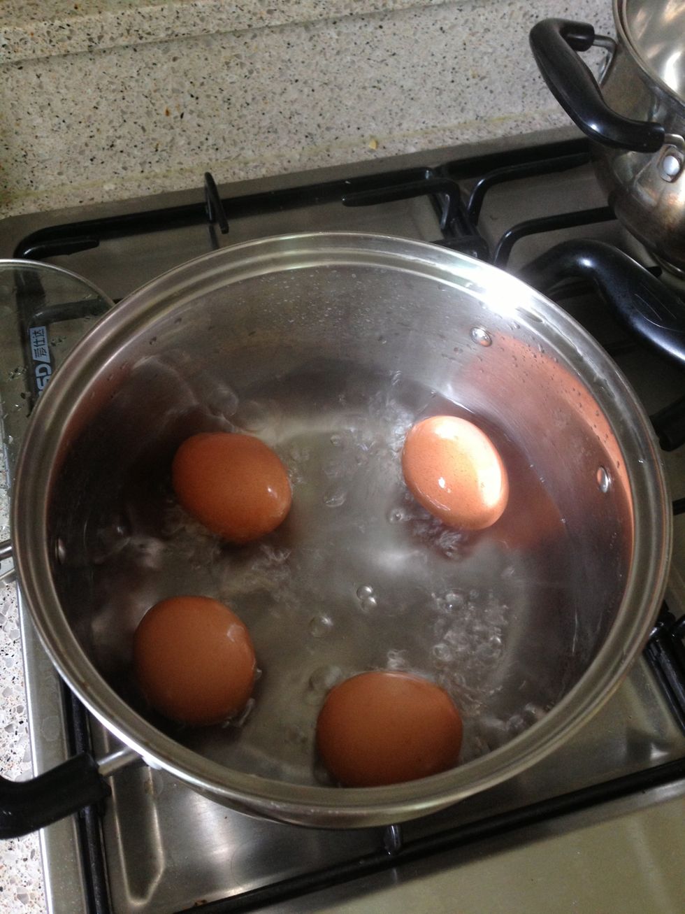 Hard boiled egg, peeled and cut in half, put on top of the noodle.