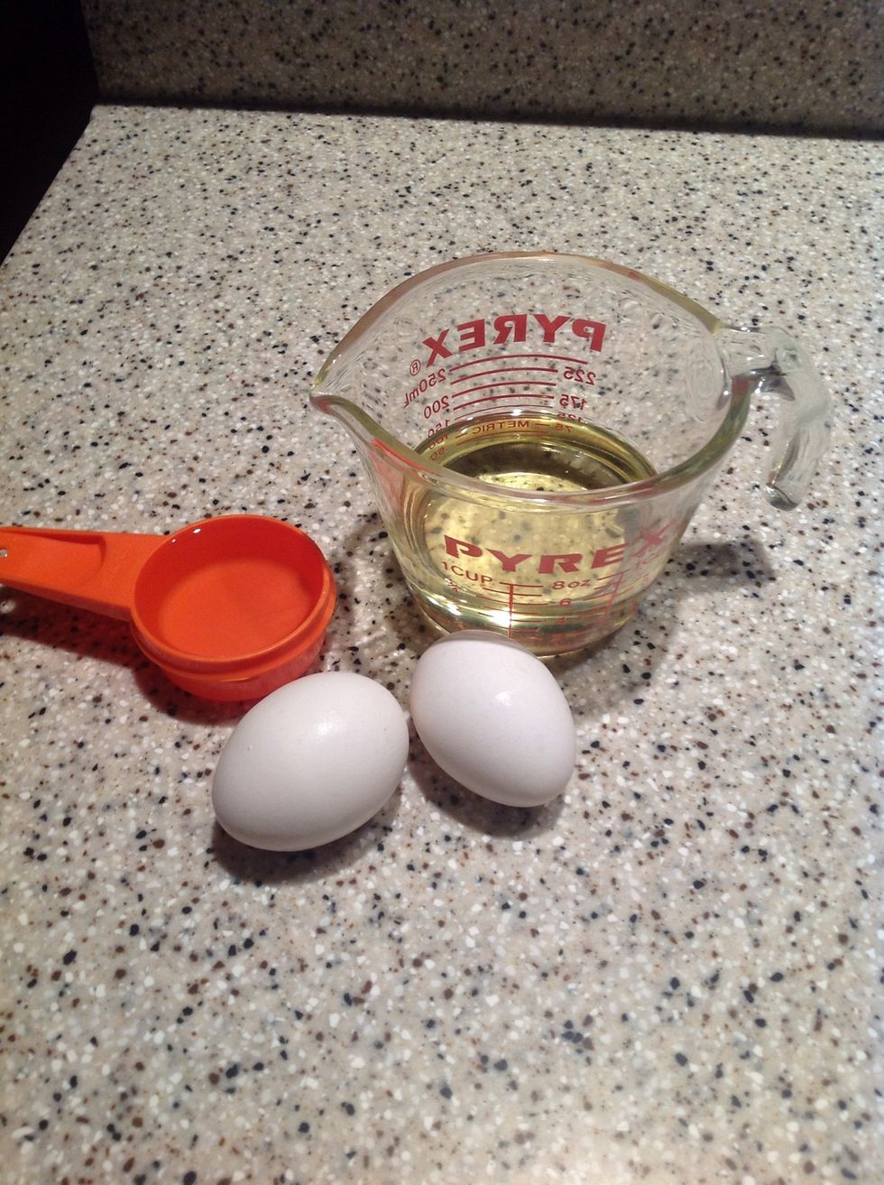 Have 2 eggs, 1/4 cup of water, and 3/4 cup of vegetable oil and take out.