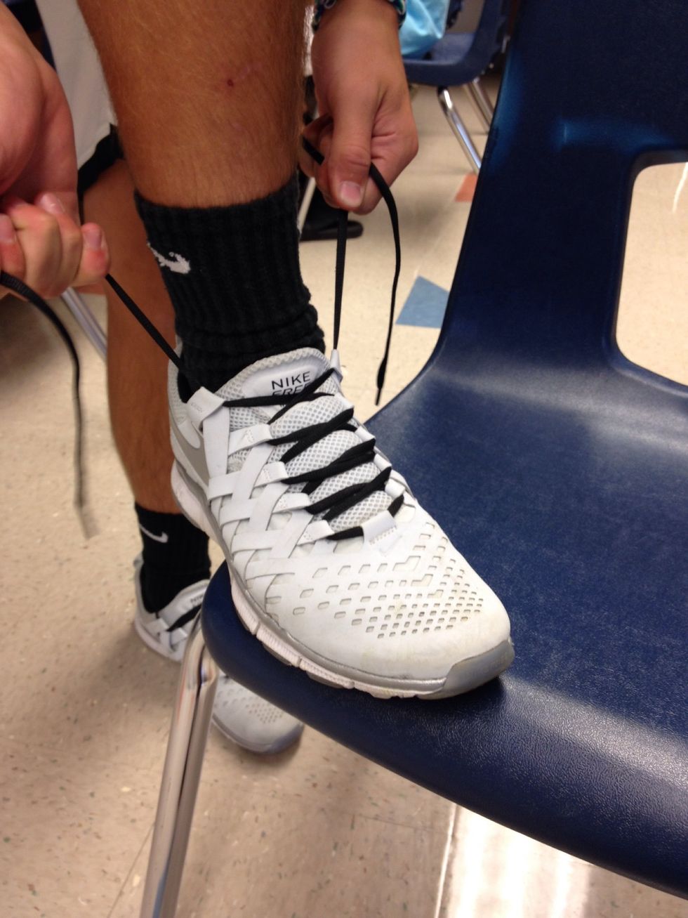 Have both hands grab the laces on each side, then pull it tight.